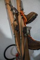 Closeup of leather boots hanging on skis in hotel photo