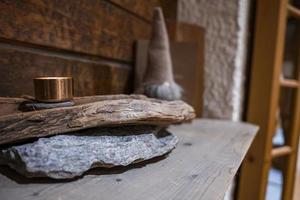 Illuminated container on stack of rustic wood in hotel photo