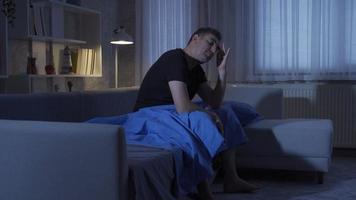 Sleep problem. Man unable to sleep at night because of headache. video