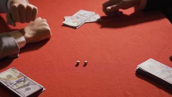 Winning and losing in gambling, rolling dice. Two men gamble at a table and roll the dice. video