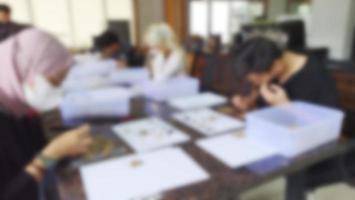 Indonesia - Jakarta, March 17 2023, Blurred background of coffee lab school participants sorting coffee photo