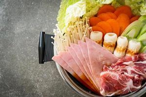 sukiyaki or shabu hot pot black soup with meat raw and vegetable photo