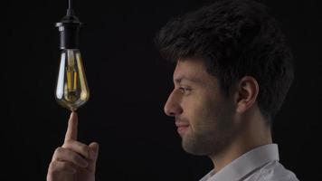 Great idea concept, Eureka. Clever man. Smart man comes up with a new idea and turns it on by touching the light bulb with his finger. video