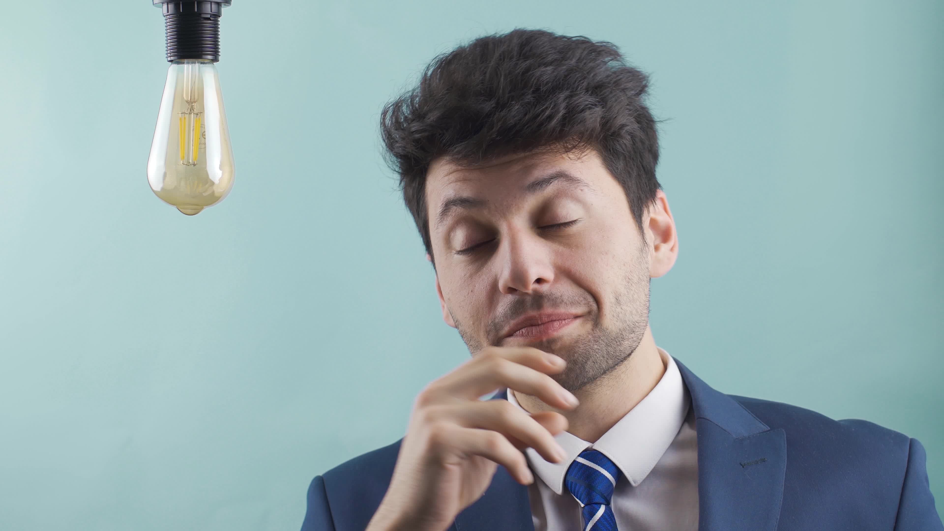 Young smart businessman finds new inventions, ideas and the idea lamp