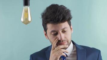 Confused businessman struggling to come up with new ideas. Idea lamp. Businessman thinks of new ideas and fails. Not turning on the idea lamp. video