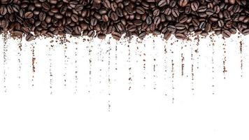 Dark roasted coffee beans setup on white background with copy space. photo