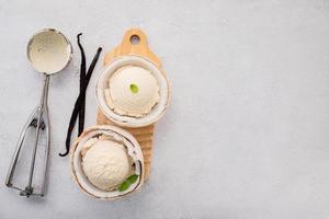 Coconut ice cream flavours in half of coconut setup on white stone background. Summer and Sweet menu concept. photo