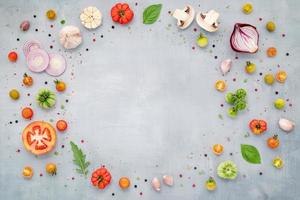 The ingredients for homemade pizza set up on grey concrete background with copy space. top view photo