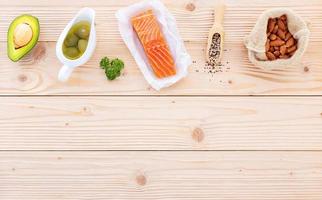 Ketogenic low carbs diet concept. Ingredients for the healthy foods selection setup on wooden background with copy space. photo