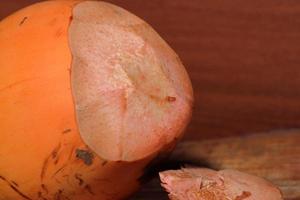 Close up of king coconut fruit half on wooden background photo