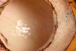 Close up of king coconut fruit half on wooden background photo