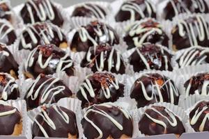 Profiteroles with chocolate cream and glaze. Chocolate Profiterole Cake photo