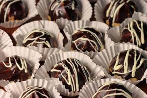 Profiteroles with chocolate cream and glaze. Chocolate Profiterole Cake photo