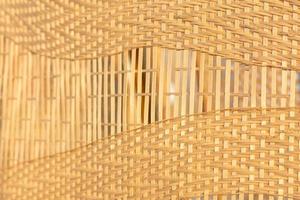 Beautiful patterned background caused by weaving bamboo into a pattern in the desired pattern to decorate the wall beautifully with natural materials. The bamboo background is woven beautifully photo