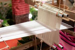 The yarn prepared inside the weaving machine is preparation for weaving local fabrics because local fabrics are handmade and have a high price because it takes quite a long time to weave. photo