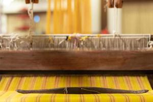 The yarn prepared inside the weaving machine is preparation for weaving local fabrics because local fabrics are handmade and have a high price because it takes quite a long time to weave. photo