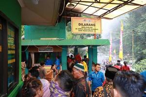 Tegal, January 2023. Photograph of busy and crowded visitors entering the Guci hot spring tourist area. photo