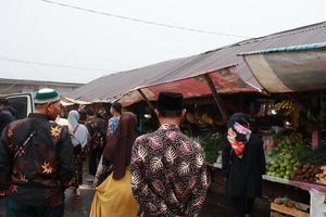 Tegal, January 2023. Group photo on the way to Guci tourist spot. with the density of visitors and various kinds of sellers on the roadside.