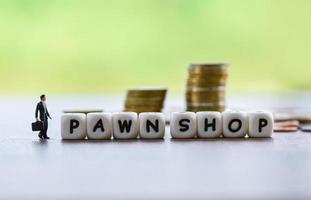 pawn shop concept - Businessman financial borrow loan pawn for cash with coin background photo