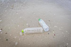 Garbage in the sea with plastic bottle on beach sandy dirty sea on the island - Environmental problem of plastic rubbish pollution in ocean photo