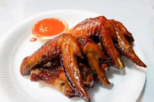 Baked chicken wings barbecue chicken wings fried on white plate and sauce photo