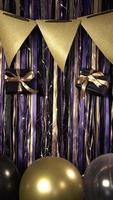 Vertical video of party celebration props birthday gold, violet and black, balloons