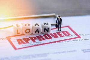 Loan approval Businessman financial Standing on loan application form for lender and borrower photo