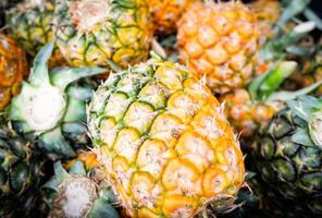 Fresh pineapple summer texture background harvest from pineapple garden tropical fruit for sale in the market photo