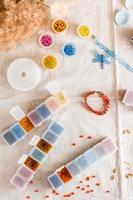 Items for beading - boxes with beads, thread and scissors on the table. Creative leisure, home teaching crafts for children. Top  and vertical view. photo