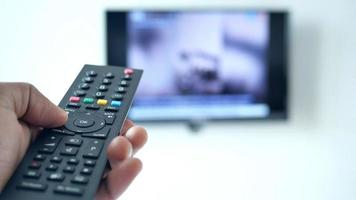 close up of man hand holding tv remote. video