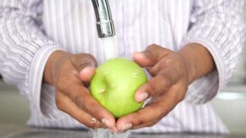 fresh apple washing with hand. video