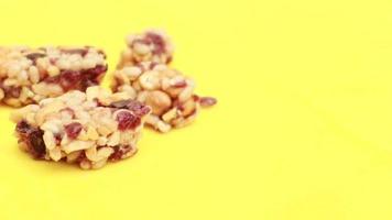 Almond , Raisin and oat protein bars on yellow background video