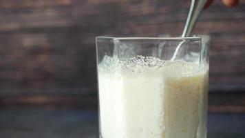 glass of whole cream milk on table , Cream of milk. video