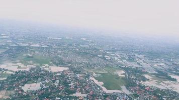 View from the window airplane flight above clouds and sea with tropical islands video