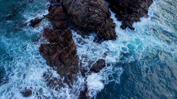 Waves With Foam Splashing On Rocky Coast In Arteixo, Spain - aerial drone shot video