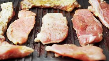 Cooked beef steak or pork ribs, toasting meat on a metal electric grill. Slow motion. Close up. video