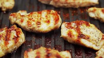 Cooked beef steak or pork ribs, toasting meat on a metal electric grill. Slow motion. Close up. video