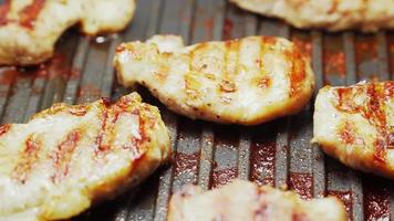 Cooked beef steak or pork ribs, toasting meat on a metal electric grill. Slow motion. Close up. video