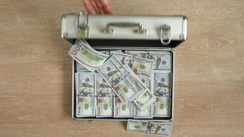 Money falls in a suitcase and it closes video