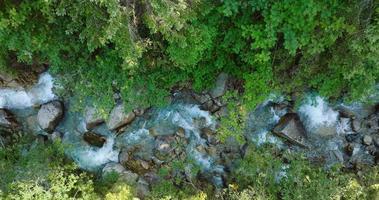 Top down view a mountain river flowing among large stones video