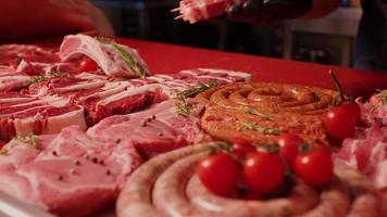 Man hands placing barbeque preps of square raw meat on skewers. video