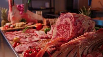 Close up of a metal table set with meat and vedetable for a butcher competition. video