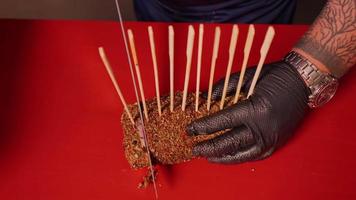 Cook slicing a rolled beef seasoned with spices. video