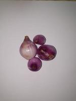Red Onions Bawang Merah or shallots on a white background. photo