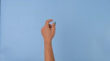 Female hand snapping fingers sign symbol on pastel blue screen background. Pack of Gestures movements and body language. video