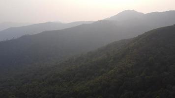 Aerial view of treeless mountain range destroyed by humans. Mountains covered in haze from burning forests.Areas with dense smog and covered with PM2.5. Air pollution and ecological problems video