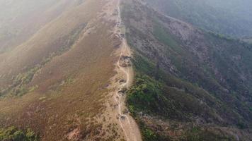 Aerial view of treeless mountain range destroyed by humans. Mountains covered in haze from burning forests.Areas with dense smog and covered with PM2.5. Air pollution and ecological problems video