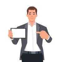 Happy confident business man showing a blank screen tablet computer and pointing towards it. Business man standing isolated in white background holding empty screen tablet PC vector