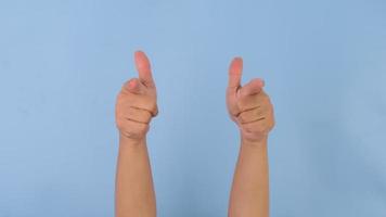 Female hands clapping and pointing with index finger on pastel blue background in studio. Pack of Gestures movements and body language. video