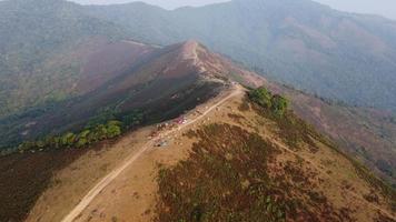 Aerial view of treeless mountain range destroyed by humans. Mountains covered in haze from burning forests.Areas with dense smog and covered with PM2.5. Air pollution and ecological problems video